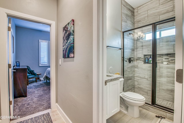 bathroom with hardwood / wood-style flooring, toilet, an enclosed shower, and a healthy amount of sunlight