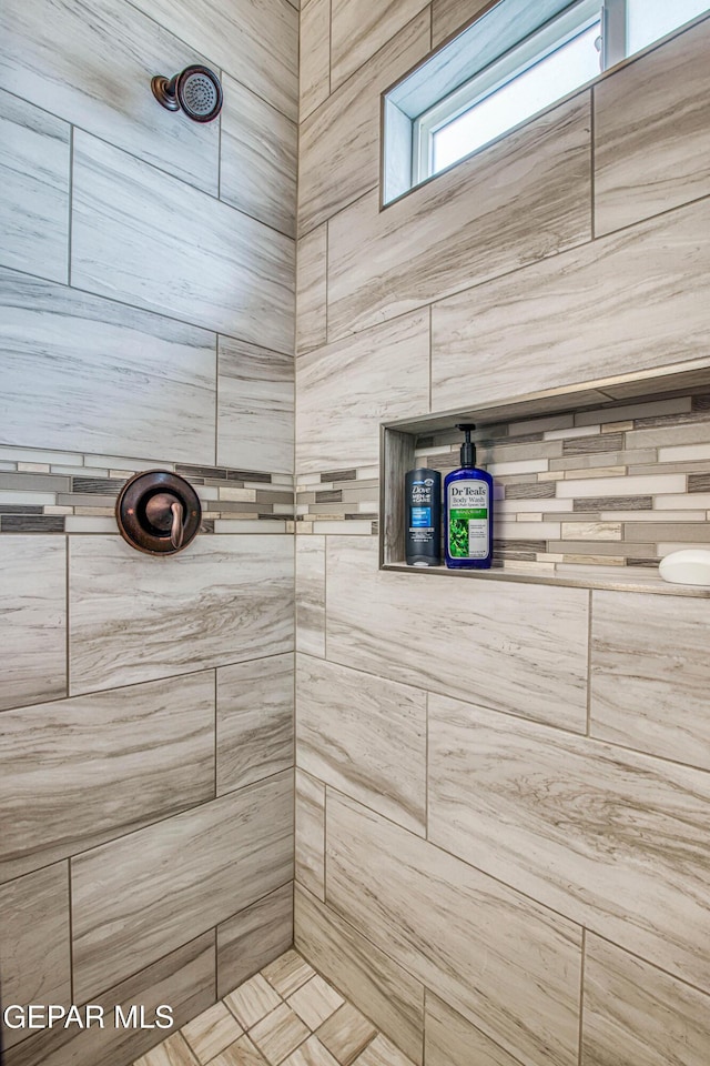 bathroom featuring tiled shower