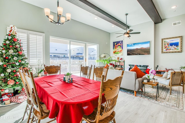 dining room with beamed ceiling, light wood-type flooring, and ceiling fan with notable chandelier