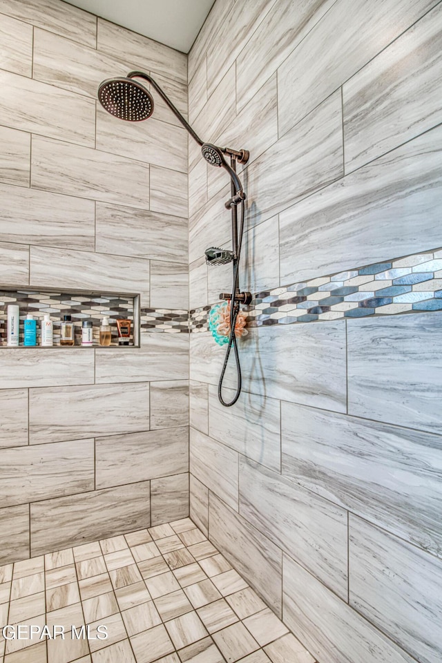bathroom with tiled shower