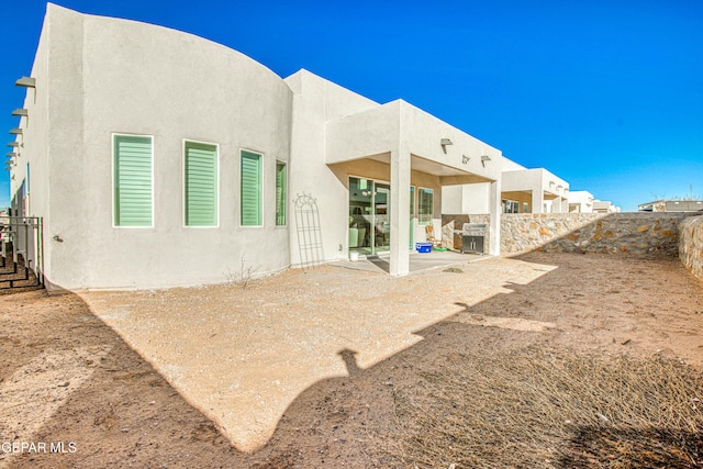 back of house with a patio