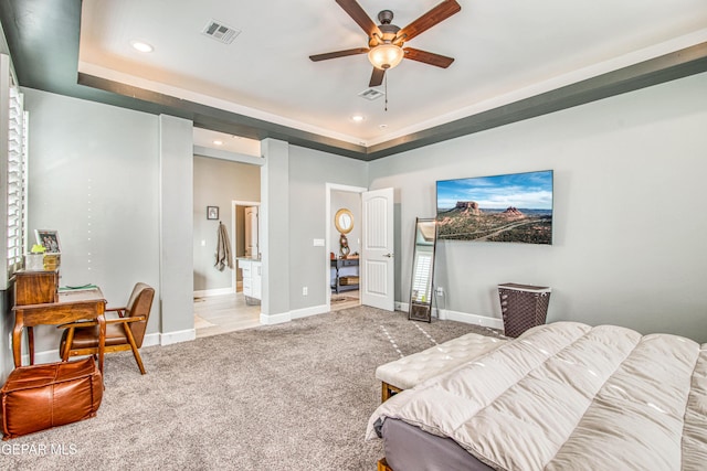living room featuring light colored carpet, a raised ceiling, and ceiling fan