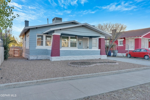 bungalow featuring a porch and central AC unit