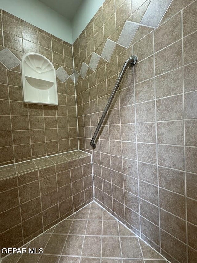 bathroom with tiled shower