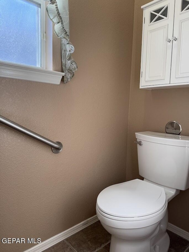 bathroom featuring toilet and tile patterned floors