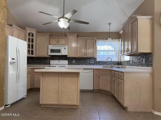 kitchen featuring a center island, white appliances, and light brown cabinetry