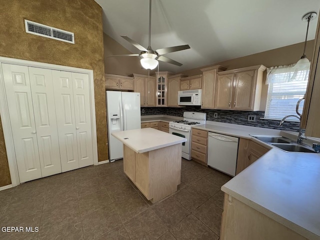 kitchen with white appliances, ceiling fan, sink, light brown cabinets, and a center island