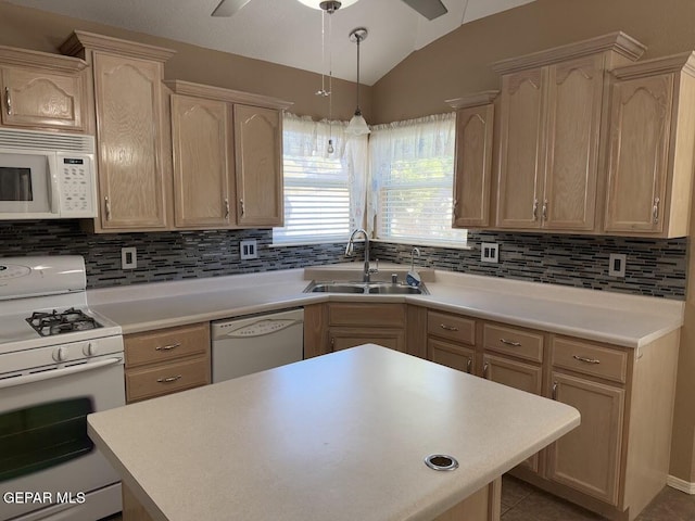 kitchen featuring vaulted ceiling, light brown cabinetry, sink, and white appliances