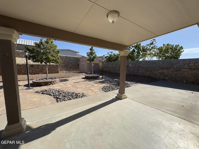 view of patio with a storage shed