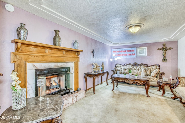 carpeted living room with a fireplace and a textured ceiling