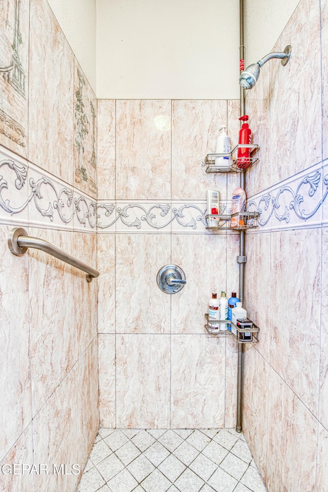 bathroom with a tile shower