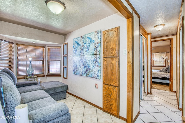 tiled living room featuring a textured ceiling