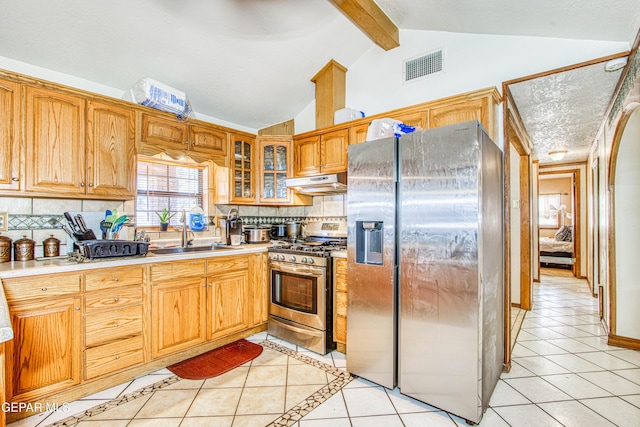 kitchen featuring tasteful backsplash, sink, light tile patterned floors, and stainless steel appliances