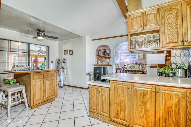 kitchen with light tile patterned floors, ceiling fan, and lofted ceiling