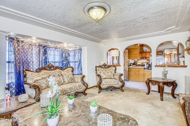 living room featuring light colored carpet and a textured ceiling