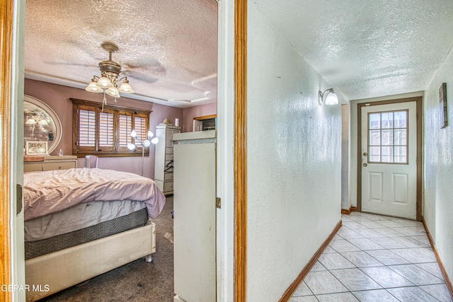 tiled bedroom featuring ceiling fan and a textured ceiling