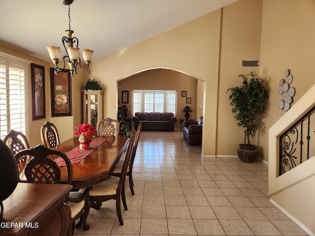 dining space featuring light tile patterned flooring and a chandelier