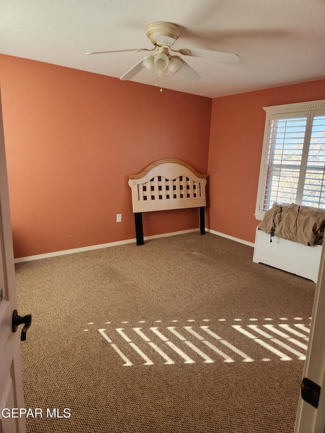 unfurnished bedroom with carpet floors and ceiling fan