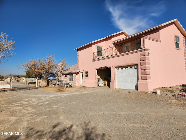 view of front of house featuring a balcony and a garage