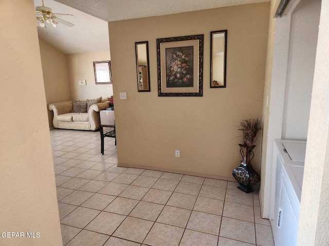 interior space with washing machine and clothes dryer, ceiling fan, vaulted ceiling, and a textured ceiling