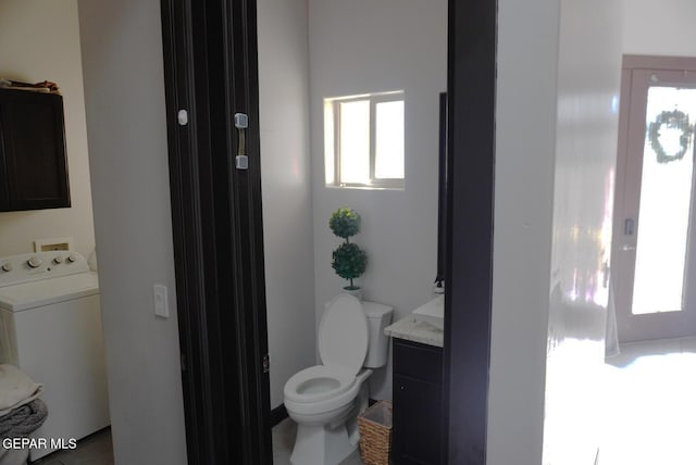 bathroom with vanity, washer / clothes dryer, and toilet