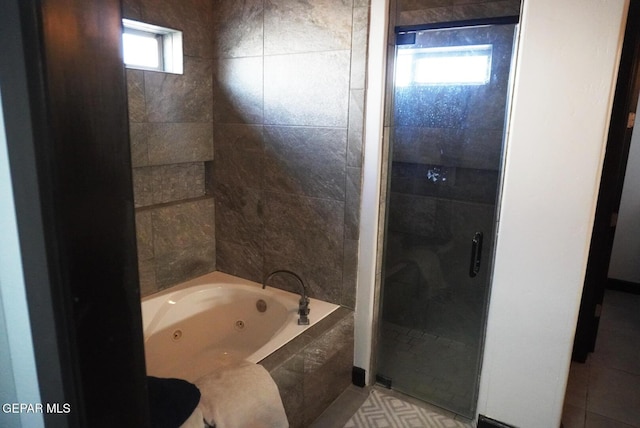 bathroom featuring independent shower and bath