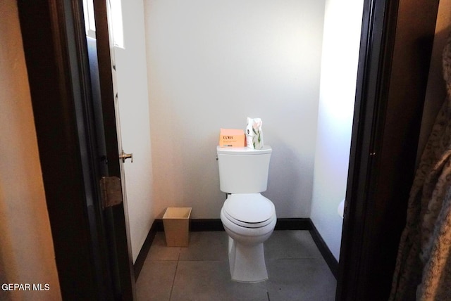 bathroom featuring toilet and tile patterned flooring