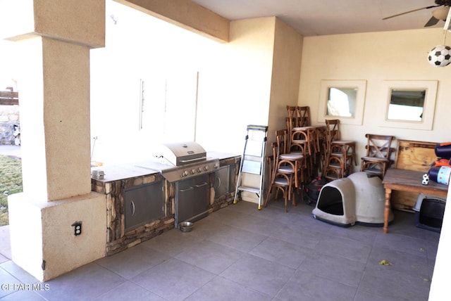 view of patio with area for grilling, grilling area, and ceiling fan