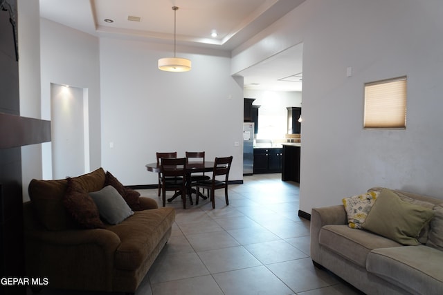 tiled living room with a raised ceiling