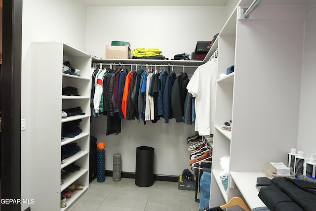 walk in closet featuring light tile patterned flooring