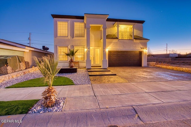 view of front of property with a garage and a balcony