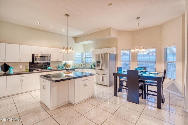 kitchen featuring white cabinetry, pendant lighting, a kitchen island, and stainless steel appliances