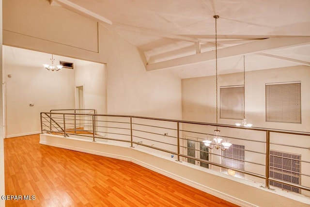 corridor featuring lofted ceiling with beams, a notable chandelier, and hardwood / wood-style flooring