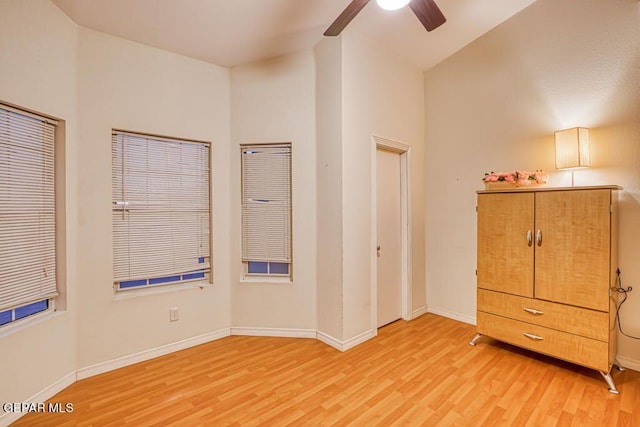 unfurnished bedroom featuring light wood-type flooring, ceiling fan, and lofted ceiling