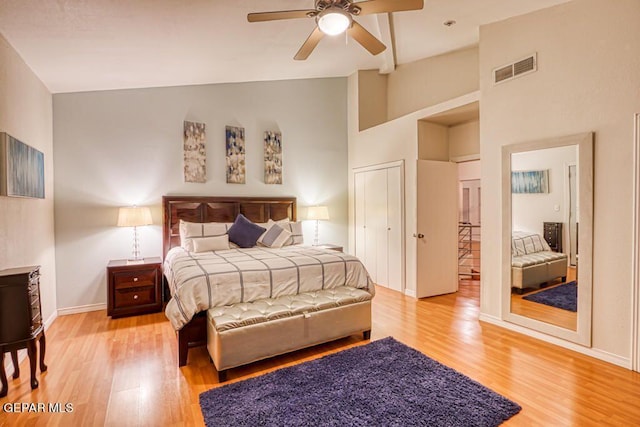 bedroom featuring ceiling fan, high vaulted ceiling, and light hardwood / wood-style flooring