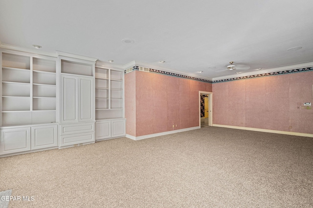 carpeted empty room with baseboards and crown molding