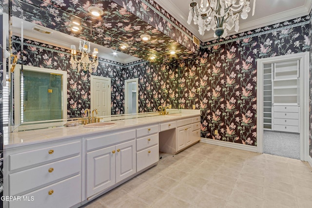 bathroom with wallpapered walls, crown molding, baseboards, and a sink