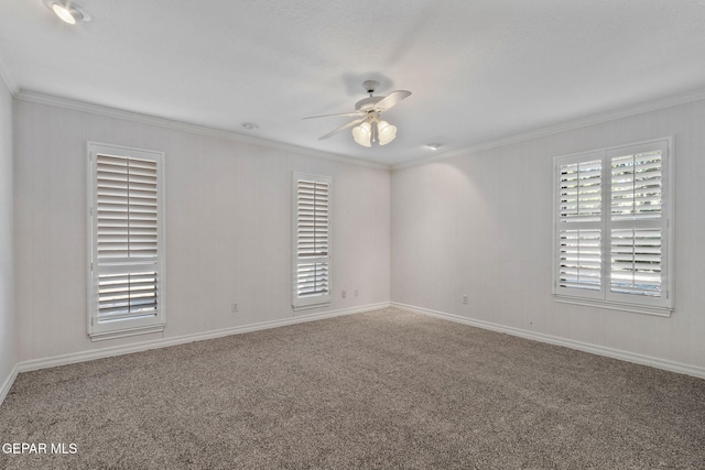 carpeted spare room featuring crown molding and a ceiling fan