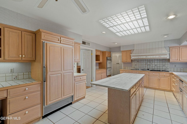 kitchen featuring custom exhaust hood, light tile patterned floors, white double oven, and tile counters