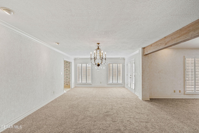 spare room featuring carpet, beam ceiling, a textured wall, a notable chandelier, and a textured ceiling