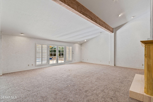 unfurnished living room with lofted ceiling with beams, baseboards, carpet floors, and a textured ceiling