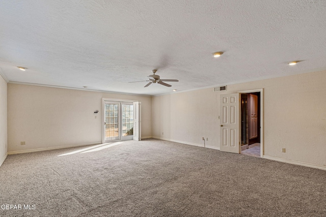 carpeted empty room featuring visible vents, baseboards, and crown molding