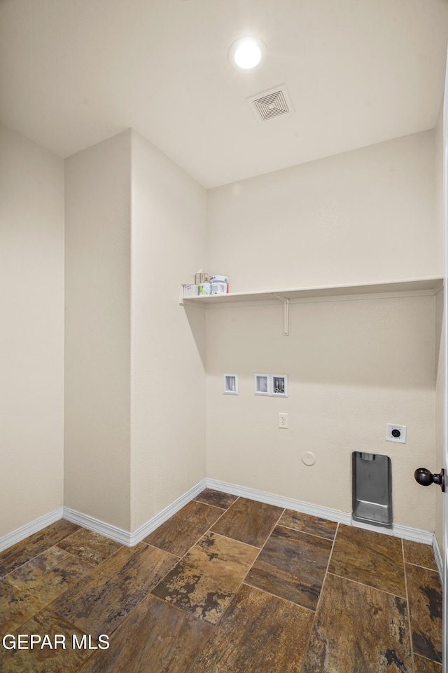 clothes washing area with electric dryer hookup, hookup for a gas dryer, and washer hookup