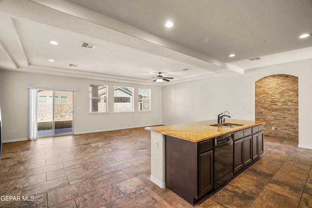 kitchen with dark brown cabinetry, a kitchen island with sink, ceiling fan, sink, and dishwasher