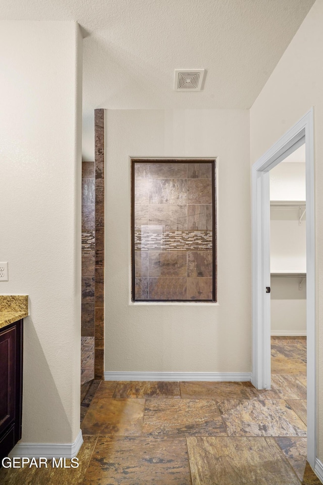 hallway featuring a textured ceiling