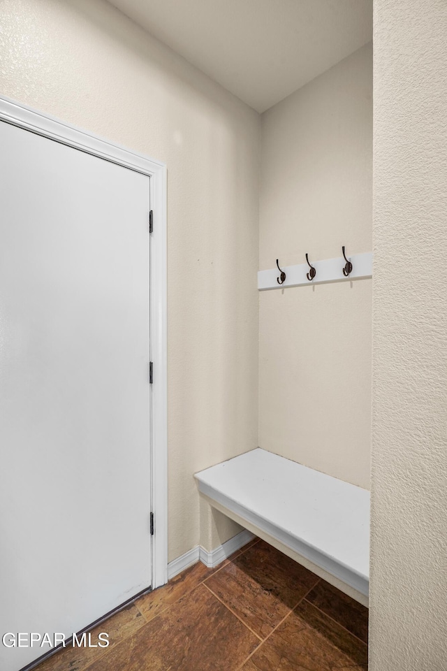 mudroom featuring dark tile patterned flooring