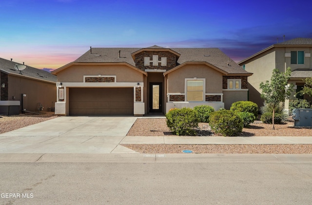 14925 Ted Banks Ave, El Paso, TX 79938 - traditional-style home with stucco siding, stone siding, an attached garage, and concrete driveway