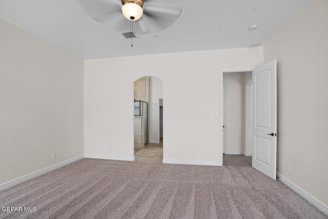 unfurnished bedroom with light colored carpet and ceiling fan