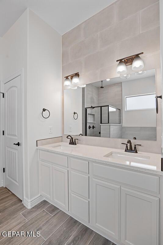 bathroom featuring vanity and a tile shower