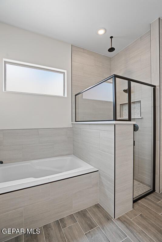 bathroom with shower with separate bathtub